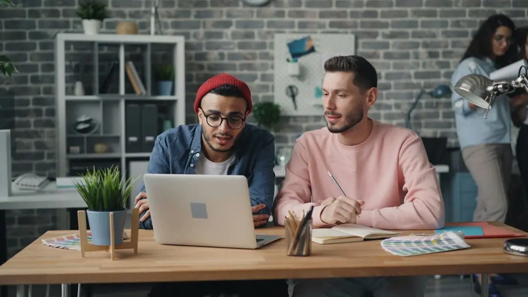 Small business owner meeting a financial advisor about startup funding, loan documents, and a business plan