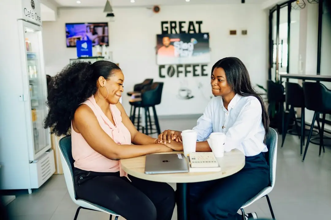 Two entrepreneurs sharing a peer conversation over coffee